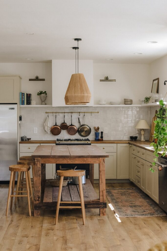 brown wooden seat beside white wooden kitchen cabinet